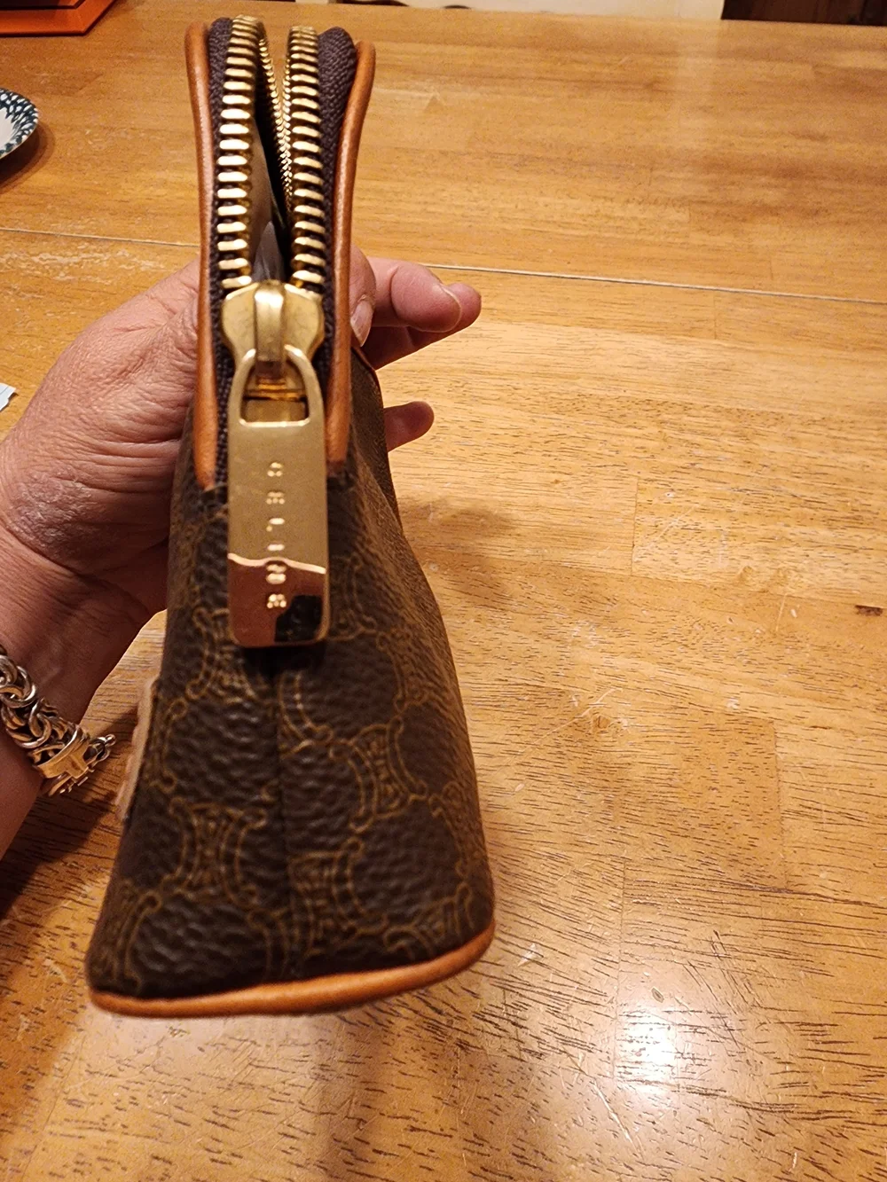 CELINE pouch is crafted from brown Triomphe canvas and features tan leather trim